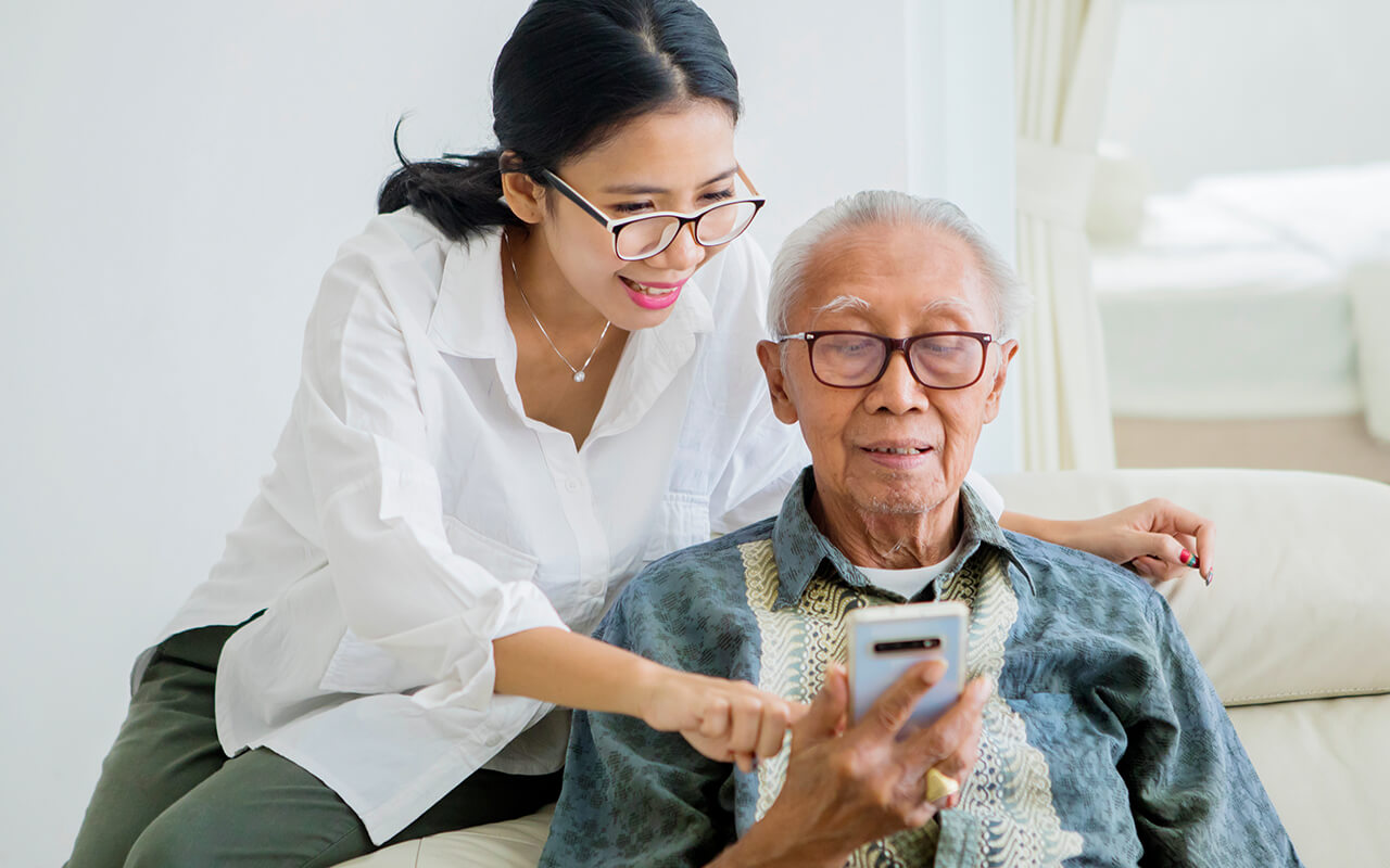 Daughter helping her father with technology