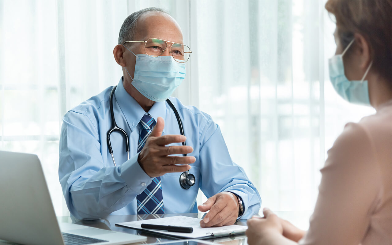Masked doctor and patient
