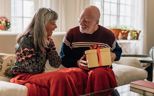 Older couple opening gifts