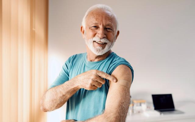 Older man with a band-aid on his arm