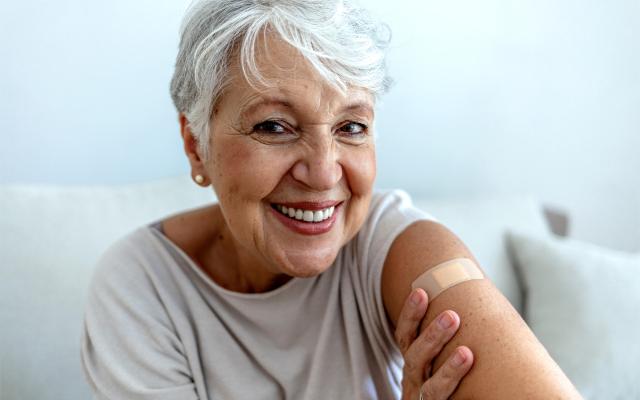 Older woman with a band-aid on her arm